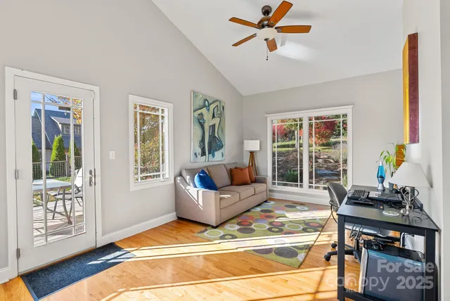 a view of a house with backyard and sitting area