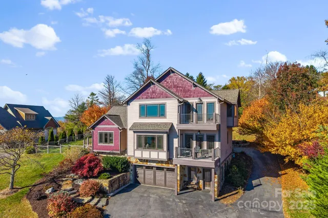 a view of multiple houses with a yard