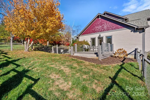a view of a house with backyard and a tree