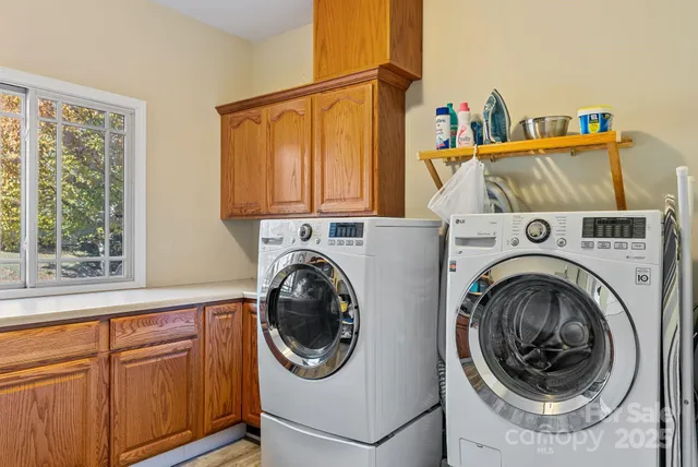 a bedroom with a bed and a flat tv screen on dresser