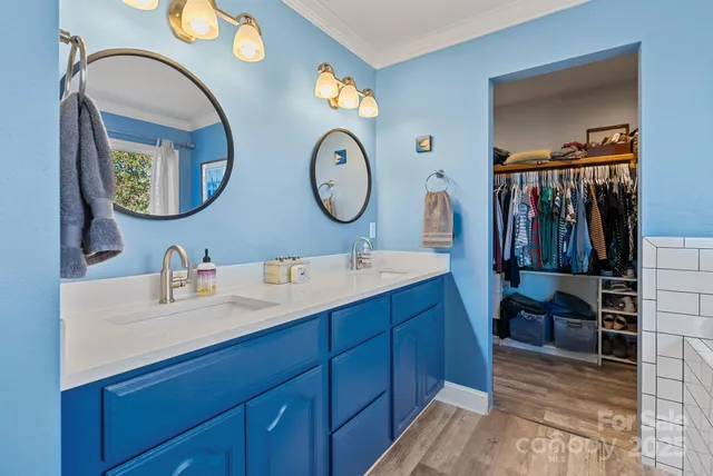 a view of a hallway with wooden floor and stairs