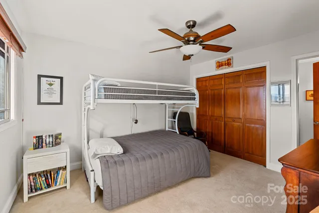 a bathroom with a granite countertop sink toilet and a mirror