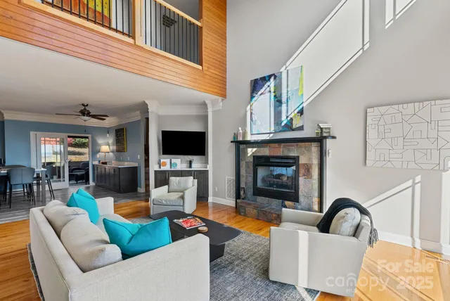 a living room with furniture a fireplace and a flat screen tv