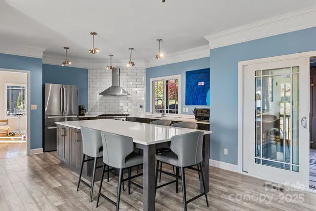 a large kitchen with a table and chairs