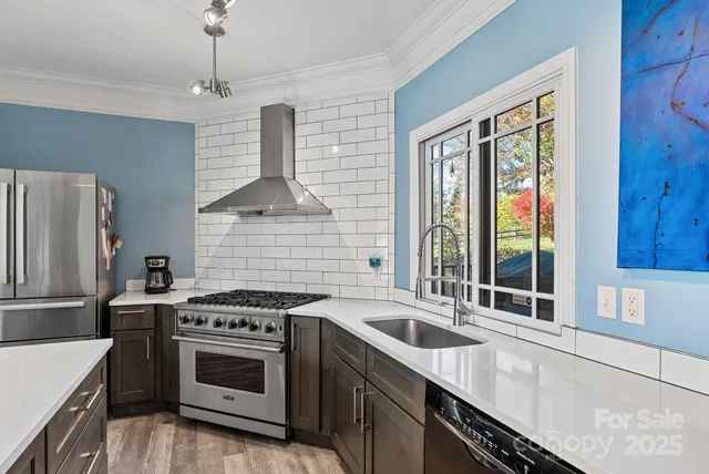 a kitchen that has a sink and a stove