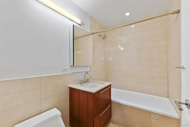 a bathroom with a double vanity sink and a bathtub