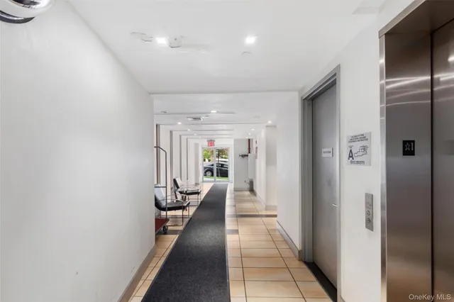 a hallway with a dining table and chairs