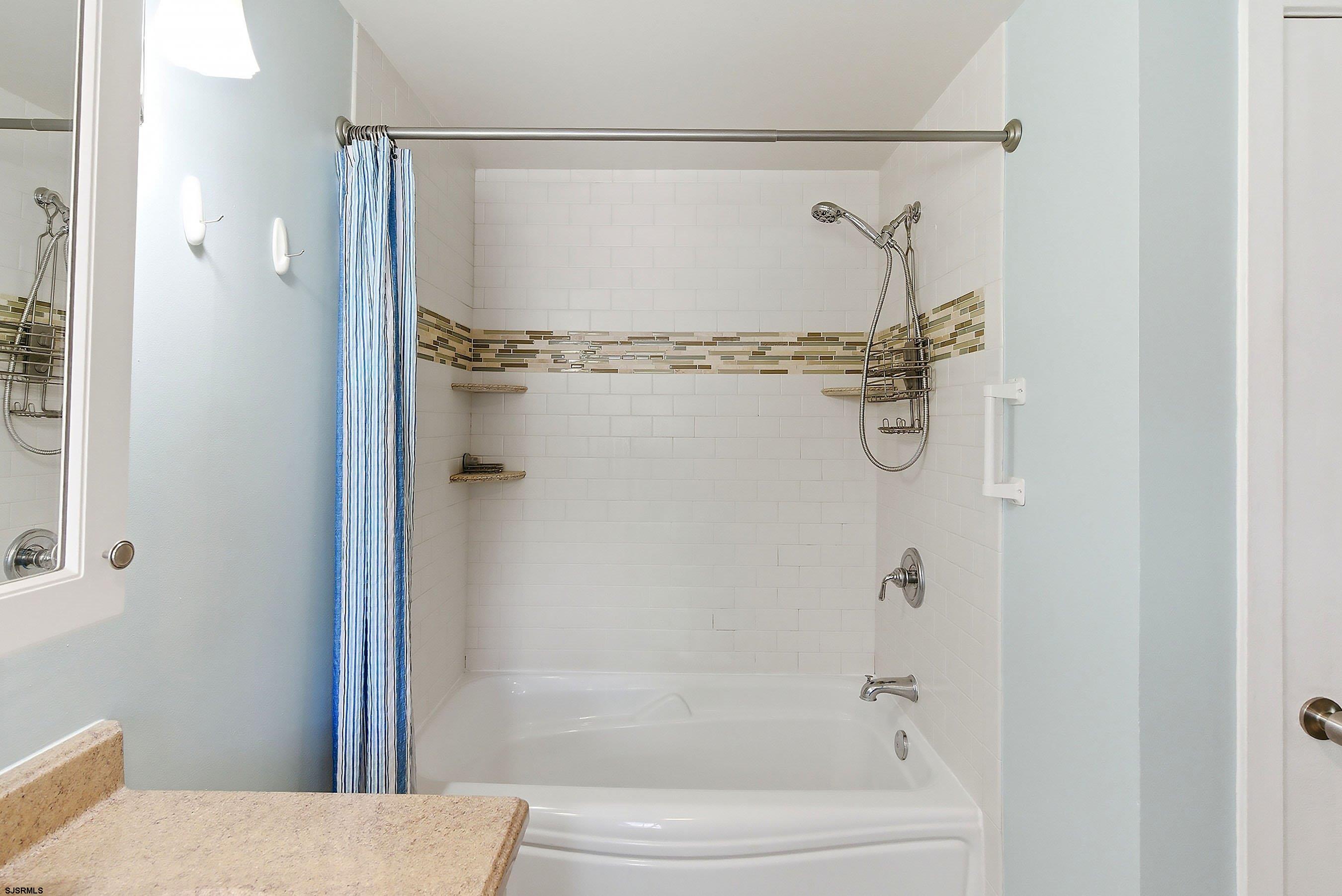 224 Meadow Ridge Road, Unit 224 Smithville, NJ 08205 - Photo 16 of 22 a bathroom with a shower and a toilet