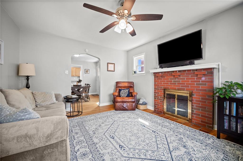 416 Phillips Avenue McKees Rocks, PA 15136 - Photo 6 of 46 a living room with furniture a flat screen tv and a fireplace