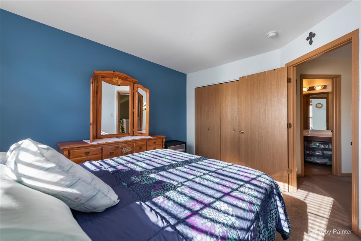 1991 West Cobblestone Road Romeoville, IL 60446 - Photo 20 of 35 a bedroom with a bed and dresser with mirror