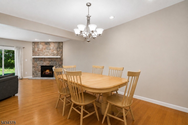 606 Park Place Springfield, NJ 07081 - Photo 7 of 21 a view of a dining room with furniture a chandelier and wooden floor