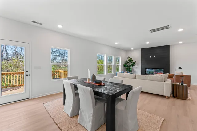 a kitchen with stainless steel appliances granite countertop a table and chairs in it