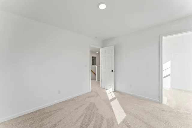 an aerial view of a city with lots of residential buildings ocean and mountain view in back