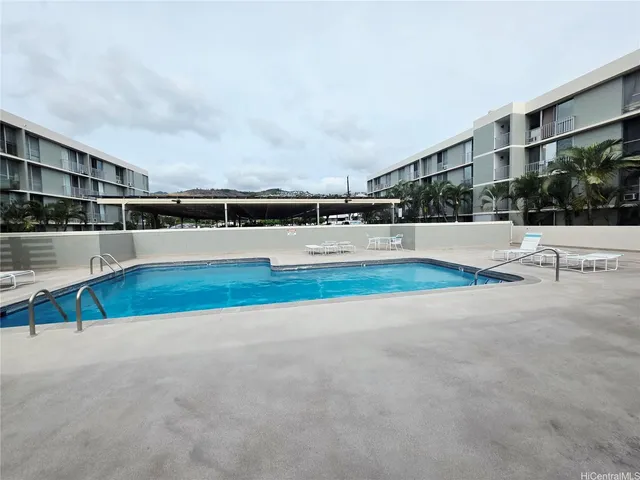 a view of swimming pool with an outdoor seating