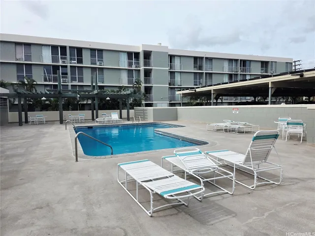 a living room with furniture a rug and white walls