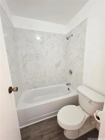 a bathroom with a toilet and a bathtub