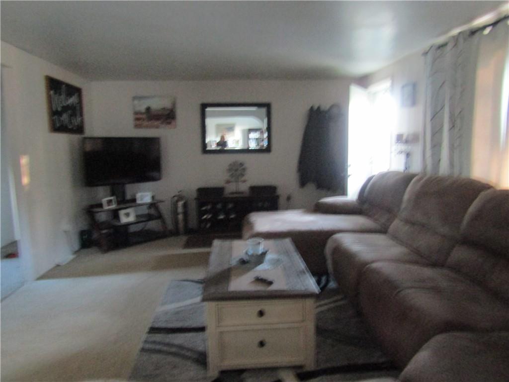32 Kaider Road Uniontown, PA 15401 - Photo 7 of 17 a living room with furniture a flat screen tv and a window