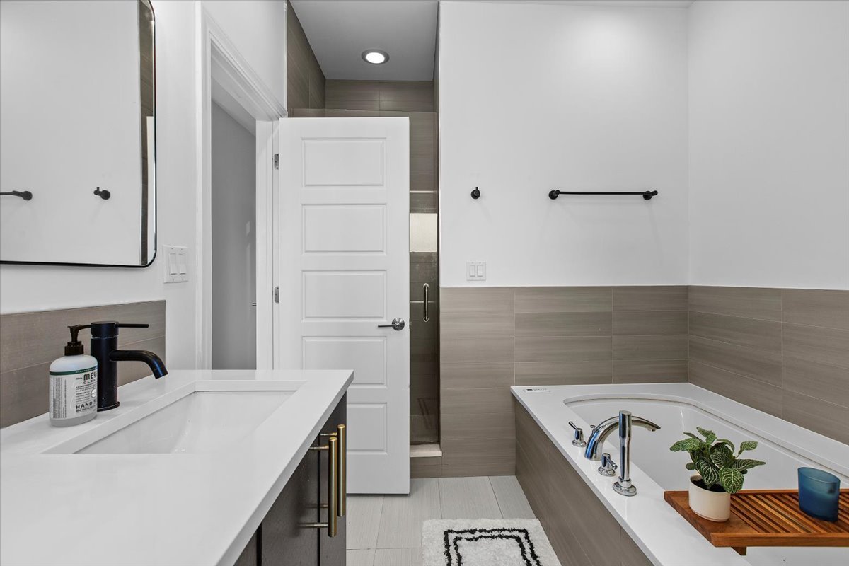2112 West Rice Street, Unit 2 Chicago, IL 60622 - Photo 12 of 19 a bathroom with a tub sink and mirror