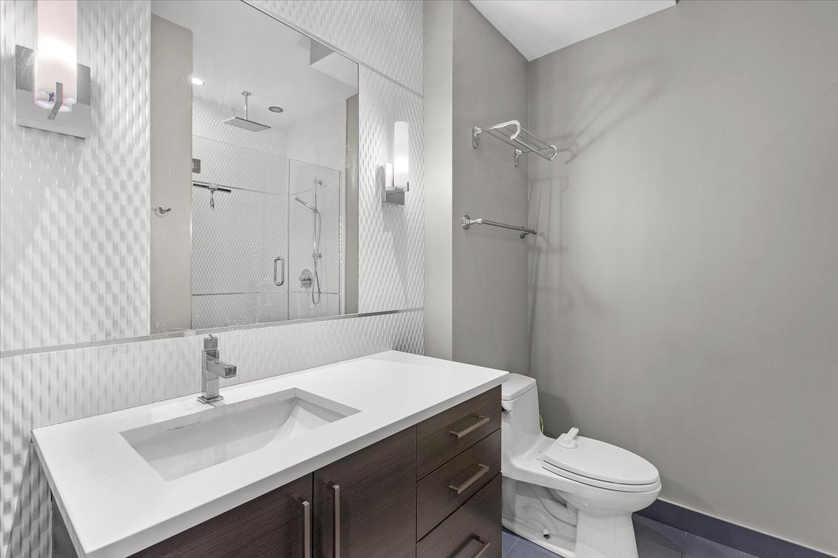 2112 West Rice Street, Unit 2 Chicago, IL 60622 - Photo 15 of 19 a bathroom with a sink toilet and vanity