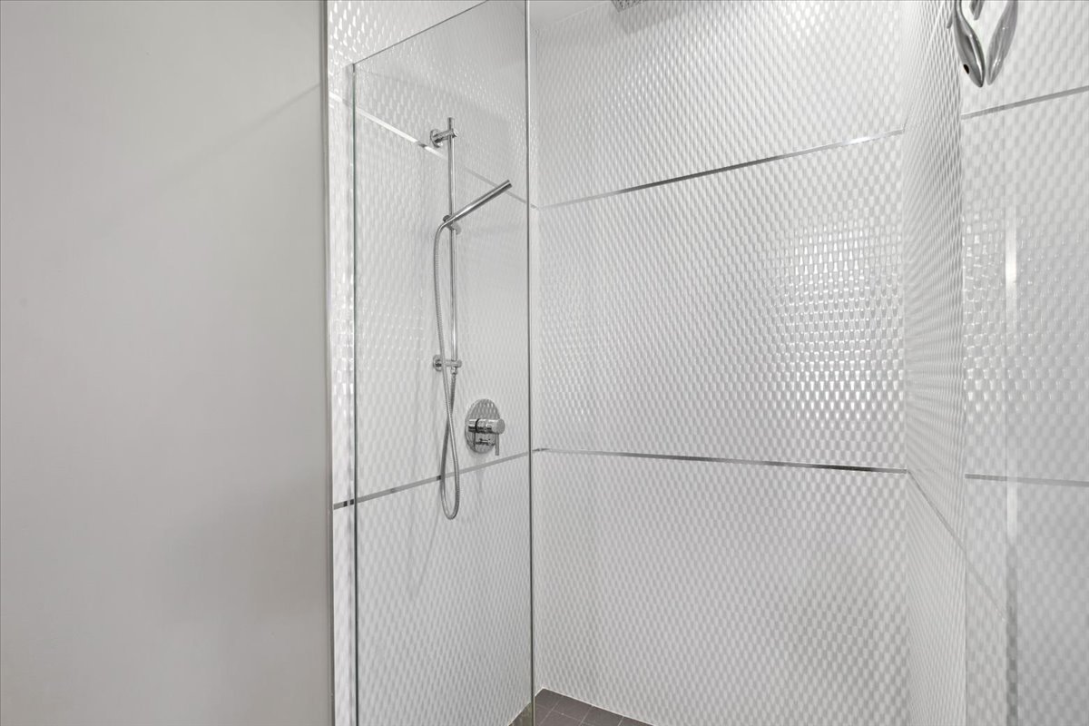 2112 West Rice Street, Unit 2 Chicago, IL 60622 - Photo 16 of 19 a bathroom with a glass shower door