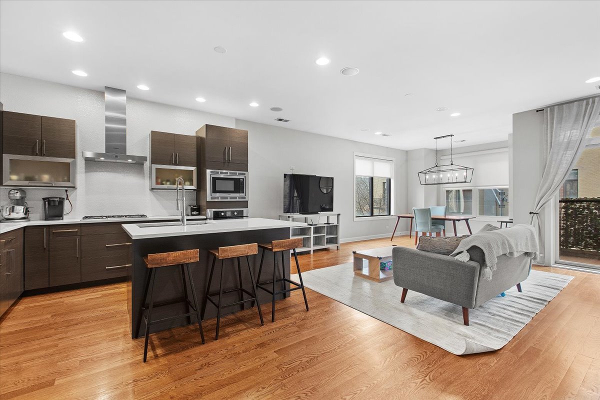 2112 West Rice Street, Unit 2 Chicago, IL 60622 - Photo 2 of 19 a living room with furniture a flat screen tv and kitchen view