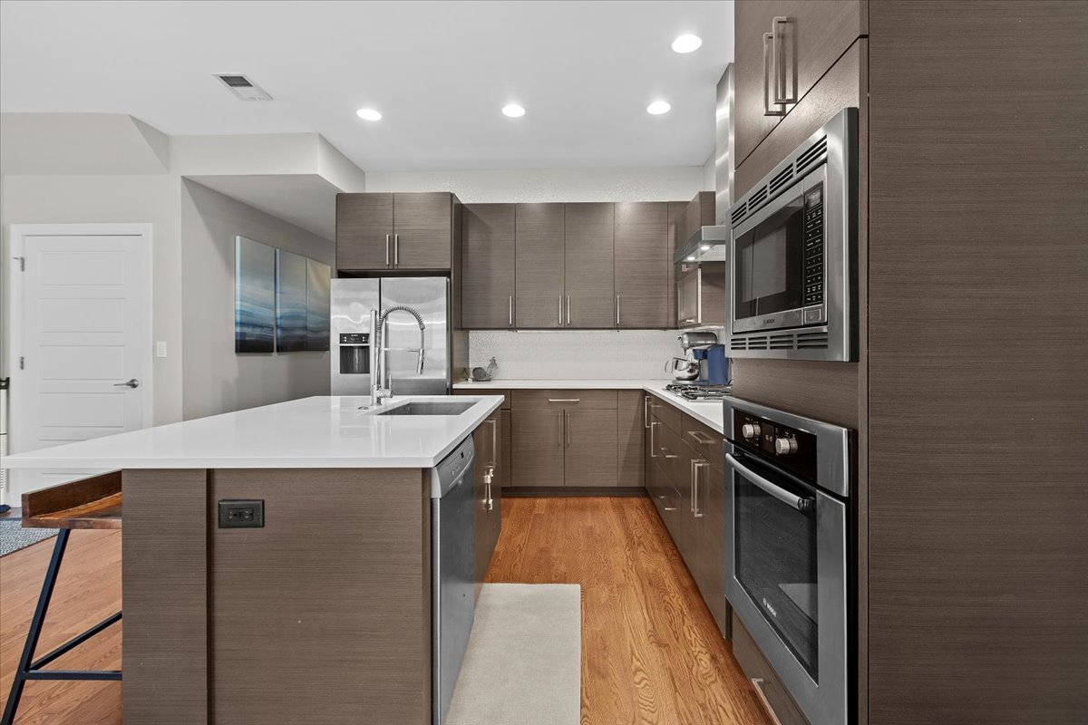 2112 West Rice Street, Unit 2 Chicago, IL 60622 - Photo 7 of 19 a kitchen with kitchen island a counter top space appliances and cabinets