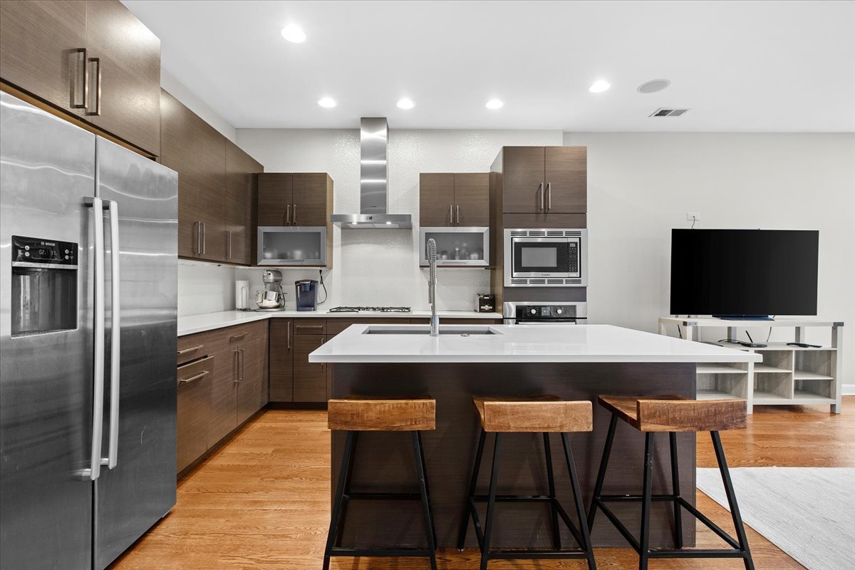 2112 West Rice Street, Unit 2 Chicago, IL 60622 - Photo 8 of 19 a large kitchen with a table and chairs