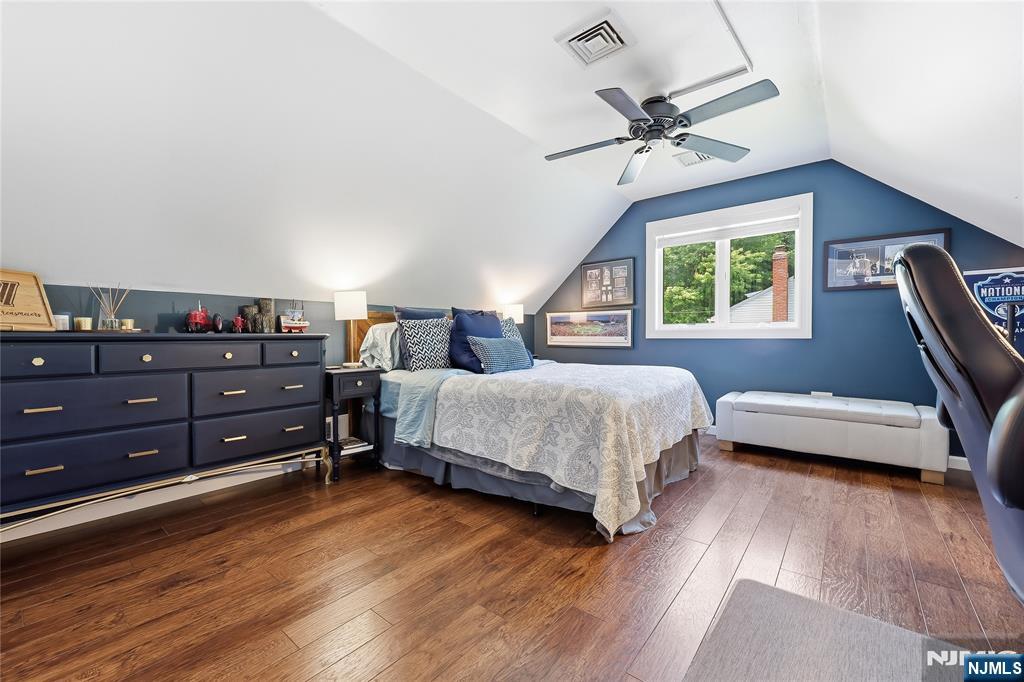 77 White Pond Road Waldwick, NJ 07463 - Photo 20 of 33 a bedroom with a bed and a chandelier