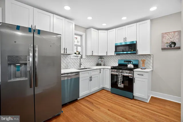 a kitchen with stainless steel appliances cabinets a sink and a stove