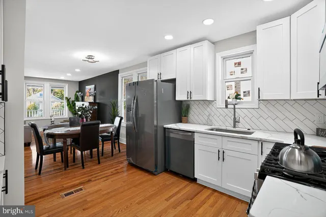 a kitchen with stainless steel appliances granite countertop a refrigerator and a stove top oven