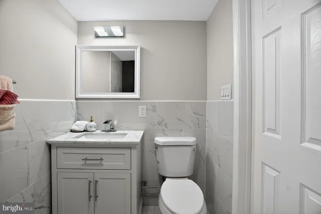 a bathroom with a toilet sink and mirror