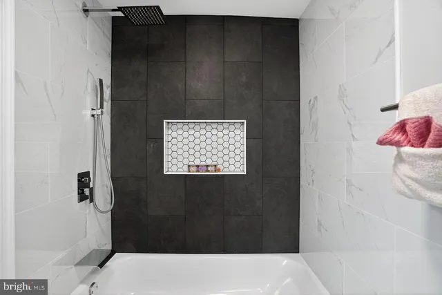 a bathroom with a bathtub and shower