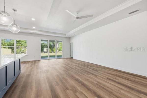 6726 Southwest 10th Lane Gainesville, FL 32607 - Photo 13 of 28 an empty room with wooden floor and windows