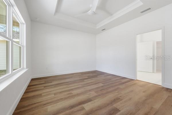 6726 Southwest 10th Lane Gainesville, FL 32607 - Photo 19 of 28 a view of empty room with wooden floor and fan