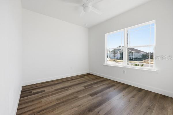 6726 Southwest 10th Lane Gainesville, FL 32607 - Photo 20 of 28 an empty room with wooden floor and windows