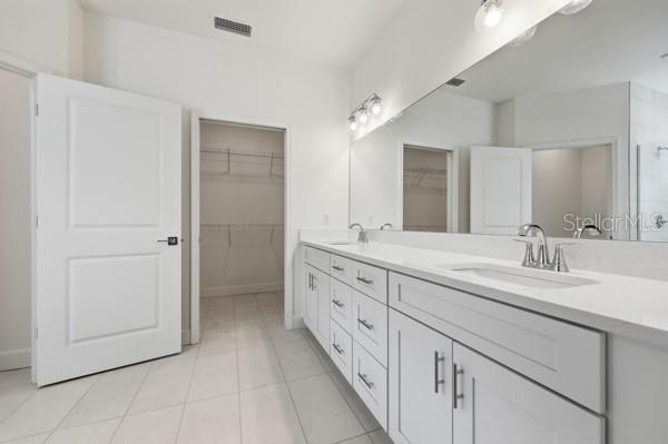 6726 Southwest 10th Lane Gainesville, FL 32607 - Photo 22 of 28 a bathroom with double sink and a mirror