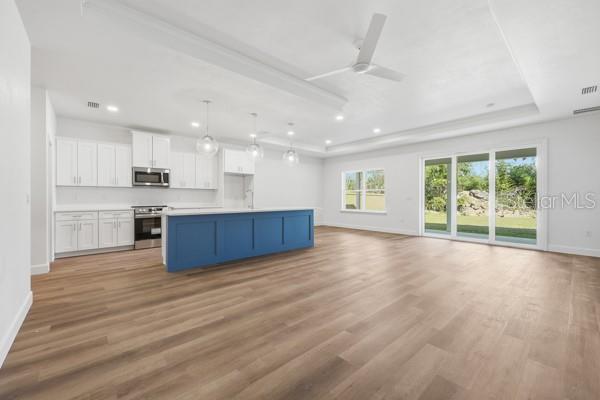 6726 Southwest 10th Lane Gainesville, FL 32607 - Photo 7 of 28 a view of kitchen with wooden floor and windows