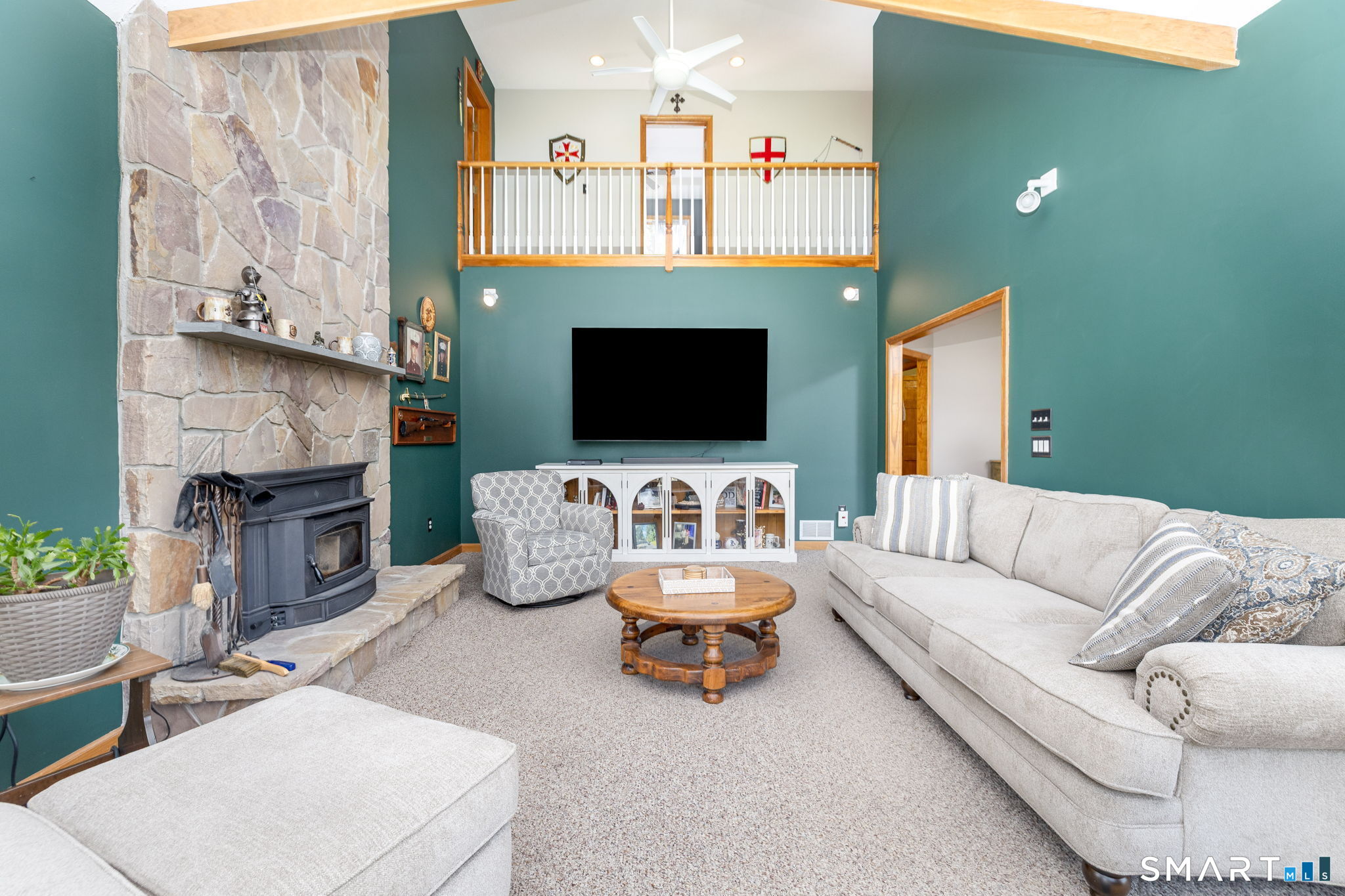 85 Salem Road East Haddam, CT 06415 - Photo 19 of 39 a living room with furniture a flat screen tv and a fireplace