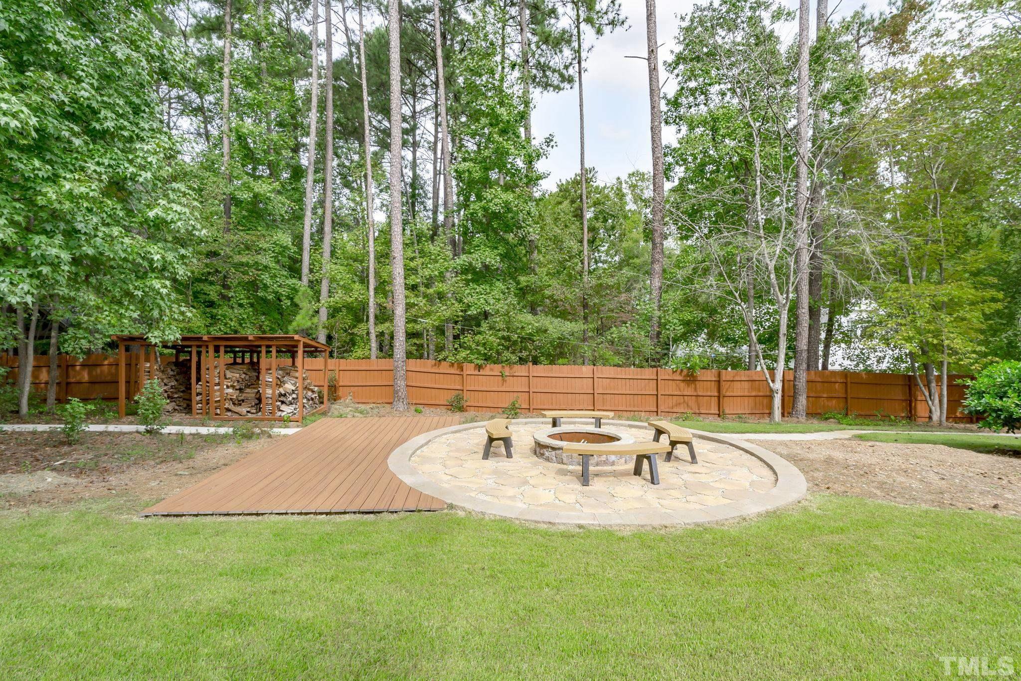 11301 Dunleith Drive Raleigh, NC 27614 - Photo 54 of 65 a backyard of a house with table and chairs