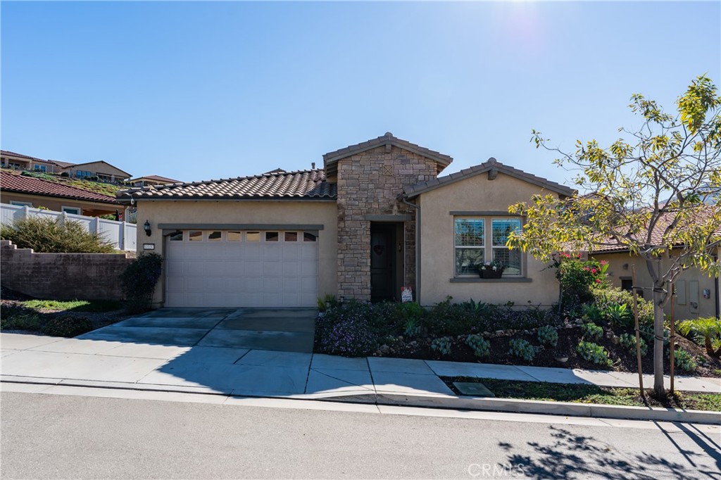 11137 Briar Rose Court Corona, CA 92883 - Photo 5 of 75 a front view of a house with a garden