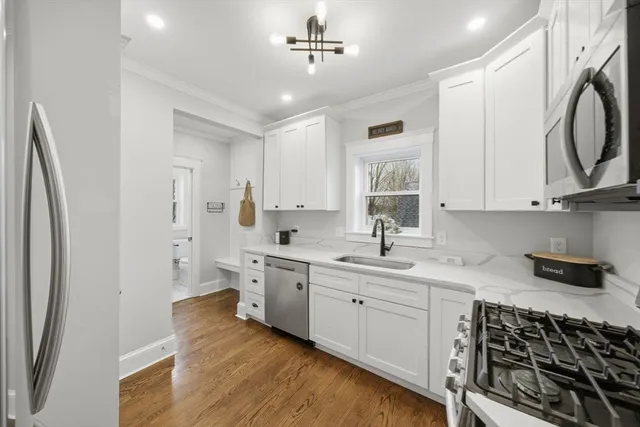 a kitchen with appliances cabinets and a sink