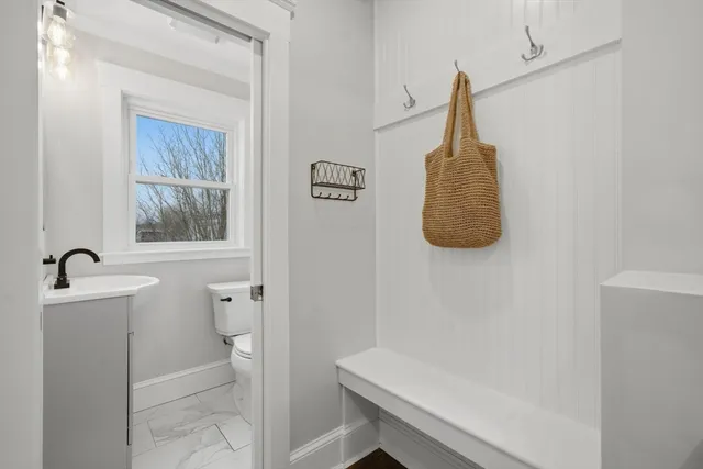 a bathroom with a toilet a sink and a window