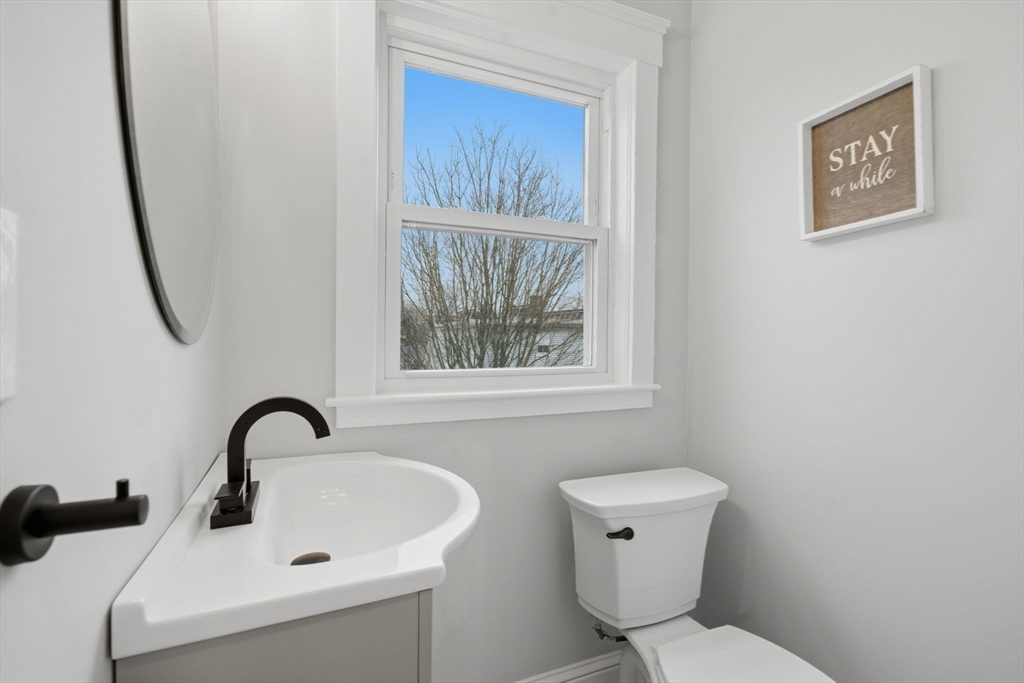 24 Prescott Street, Unit 3 Boston, MA 02136 - Photo 15 of 29 a bathroom with a toilet a sink and a window