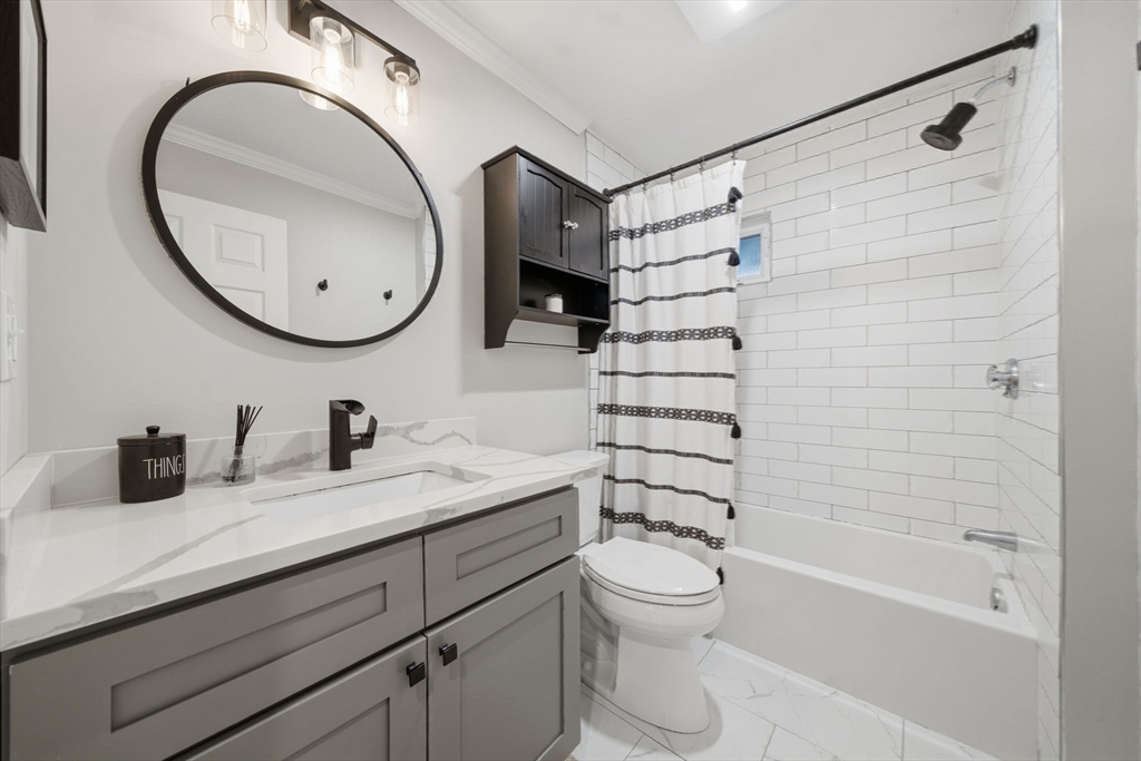 24 Prescott Street, Unit 3 Boston, MA 02136 - Photo 18 of 29 a bathroom with a granite countertop sink a toilet and a mirror