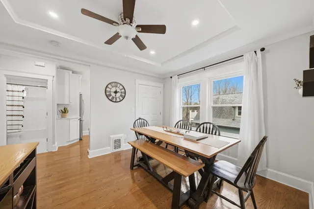 a living room with a table chairs and a window