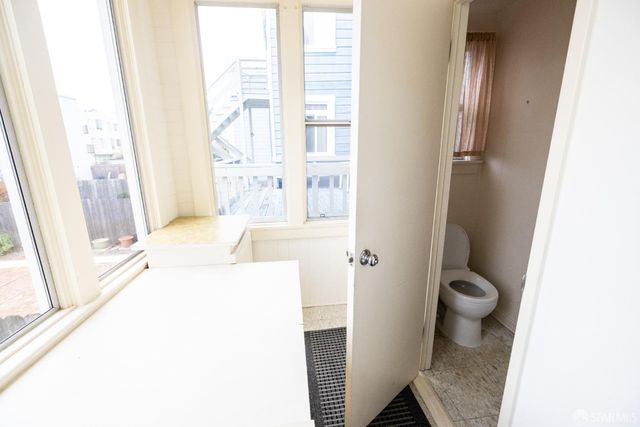 a living room with a fireplace and a walk in closet
