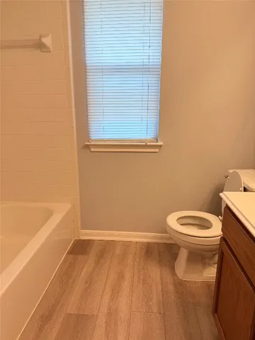 a view of an empty room with a fireplace and a window