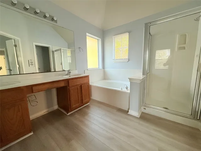 a bathroom with a tub sink and a mirror