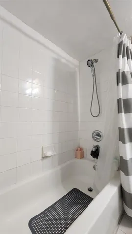 a bathroom with a bathtub and shower
