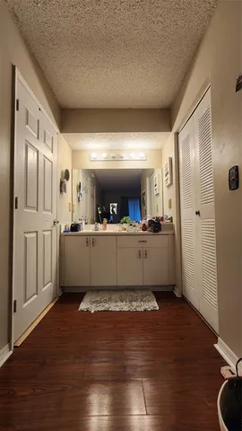 a bed sitting in a bedroom and dressers next to a larger window